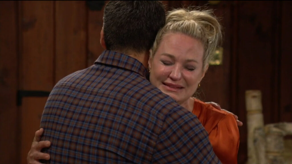 Sharon cries as Nick comforts her.
