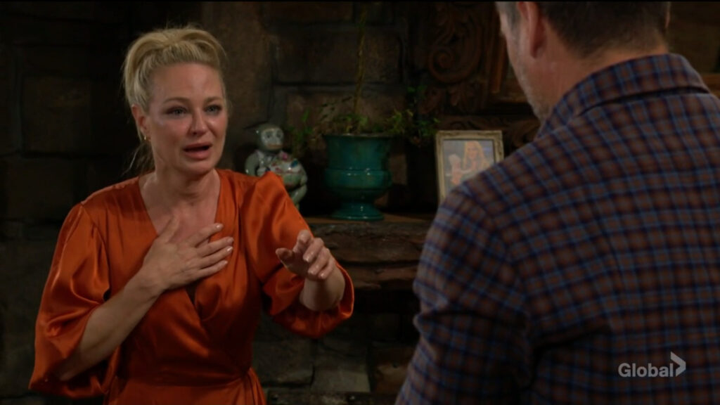 Sharon clutches her chest and cries as she talks with Nick.