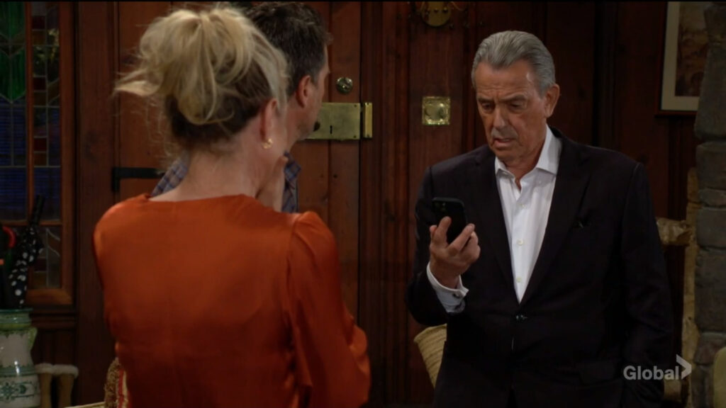 Victor looks at Sharon's phone.