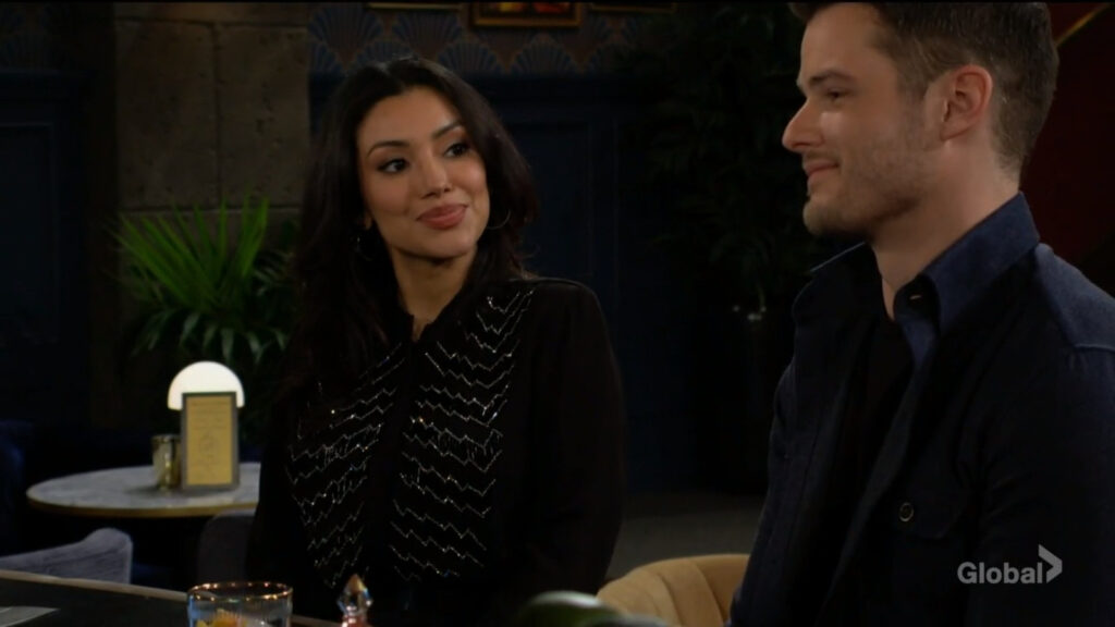 Audra smiles at Kyle as they talk.