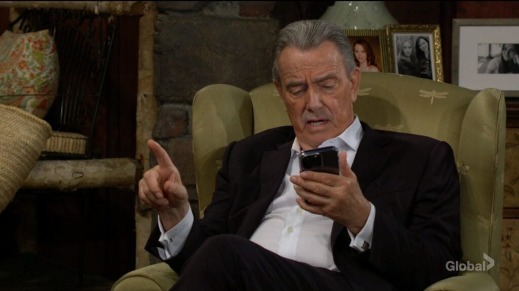 Victor looks up a number on his phone as he talks with Sharon and Nick.