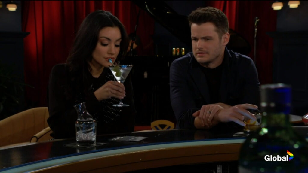 Kyle sits at the bar talking with Audra as she sips on a martini.