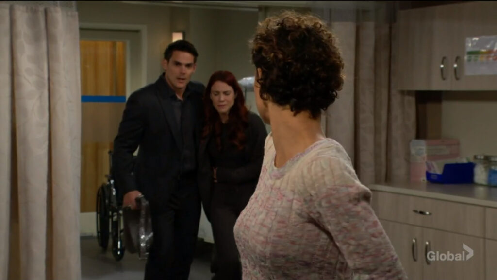 Adam and Sally walk into the hospital and talk with Elena.