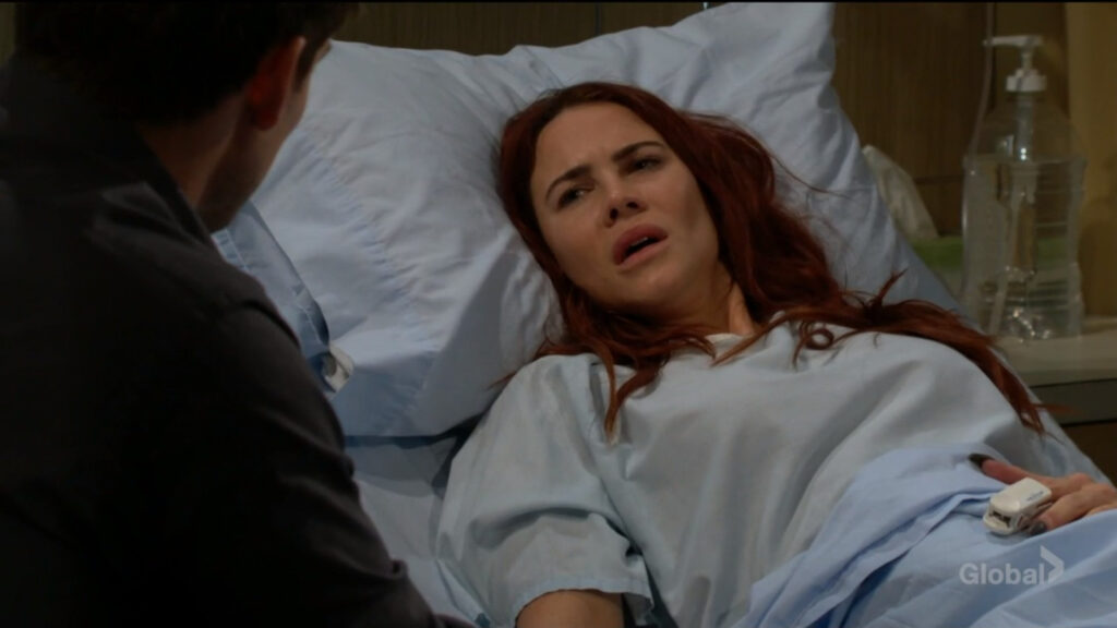 Sally talks to Adam as she lies in the hotel bed.