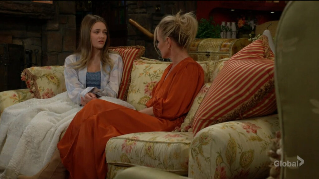 Faith sits on the couch under a blanket while she talks with Sharon, who's sitting beside her.