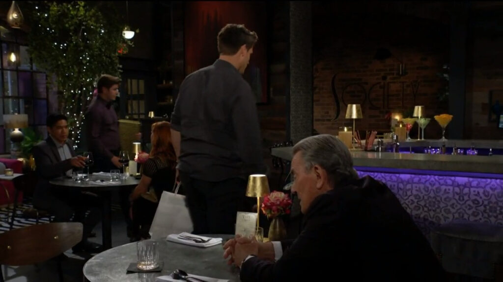 Adam leaves the restaurant as Victor watches.