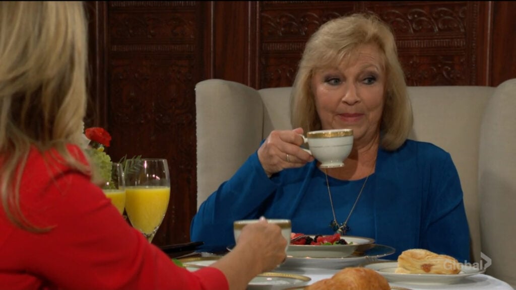 Traci sips her tea as she talks with Zelda.