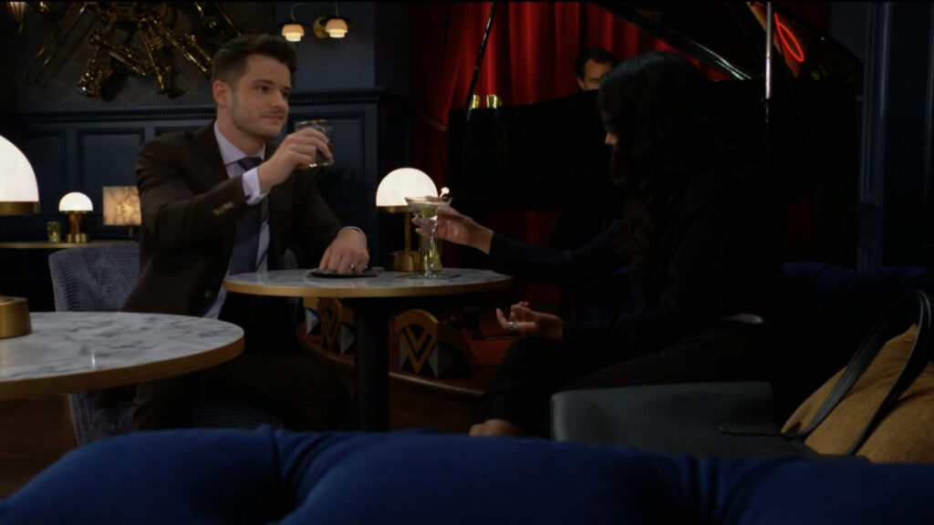 Kyle raises his glass in a toast with Audra.