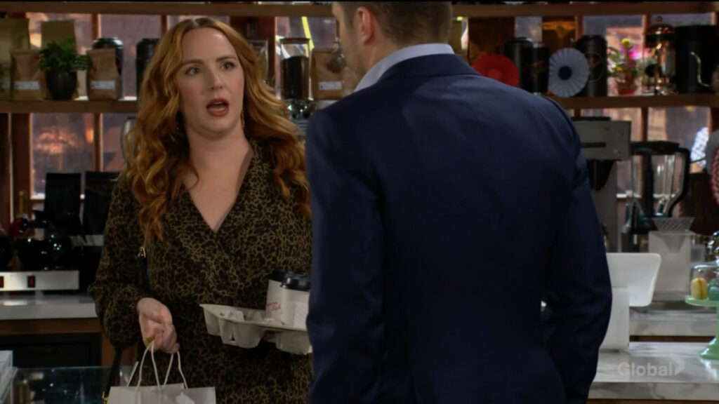 Mariah carries her coffee as she talks to Kyle.
