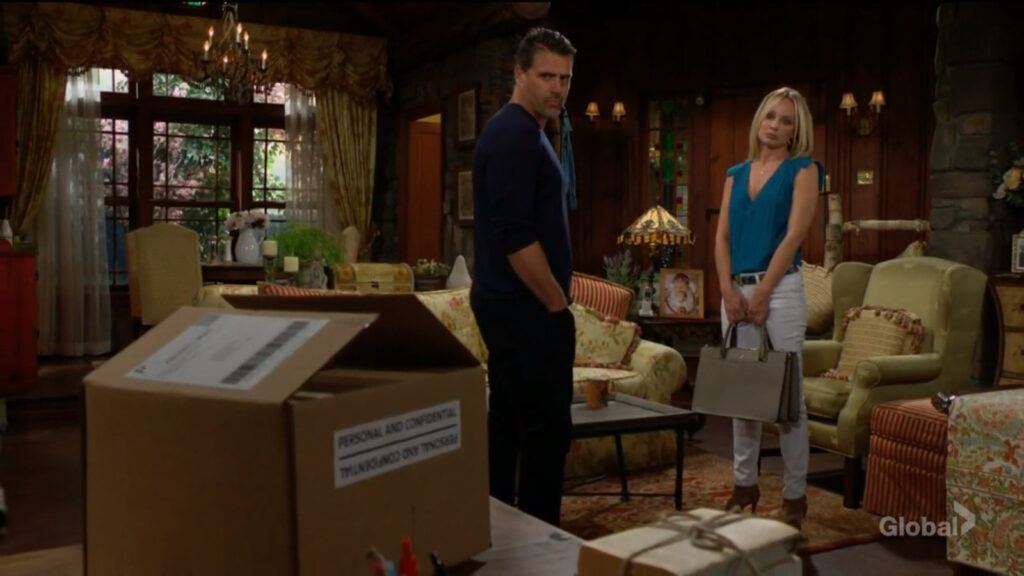Sharon and Nick talk as they look at the box Cameron sent.