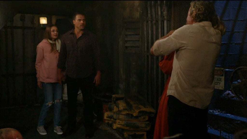 Nick talks to Cameron, who's holding Sharon hostage, while Faith looks on.