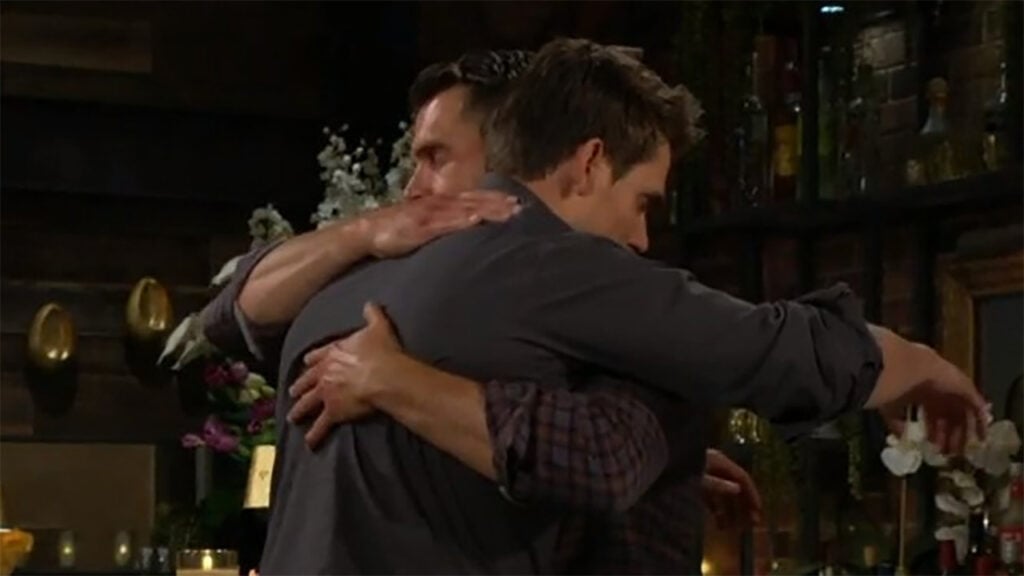 Adam and Nick hug.