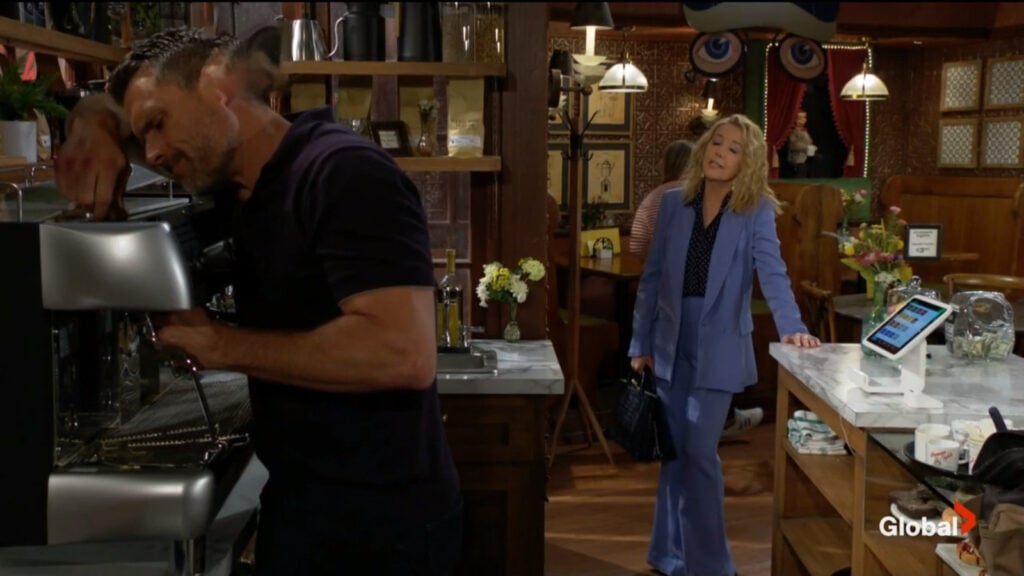 Nikki talks with Nick as he repairs an espresso machine.