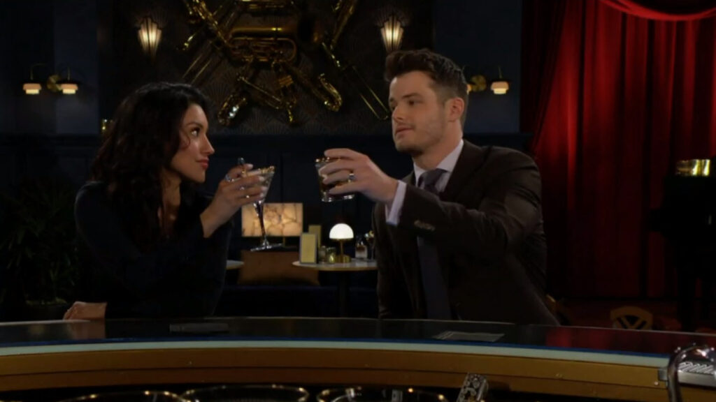 Kyle and Audra raise their glasses in a toast.