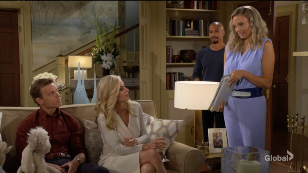 Ashley holds out a wedding planning album as she talks with Ashley and Tucker while Devon looks on.