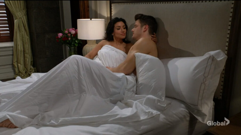 Kyle and Audra lie in bed talking.