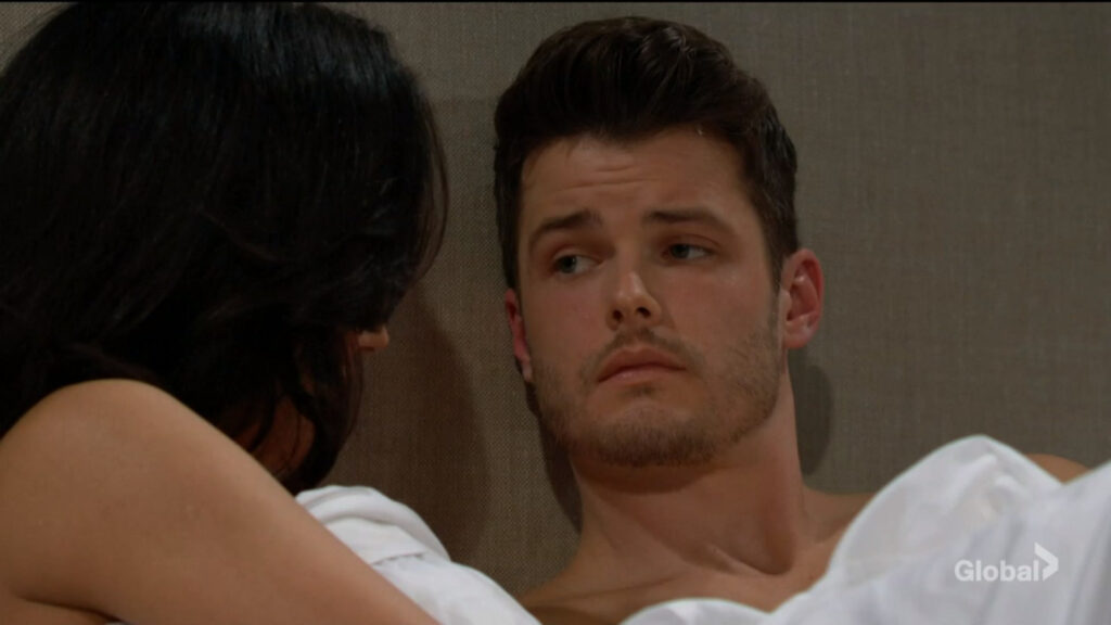 Kyle looks at Audra as they talk.