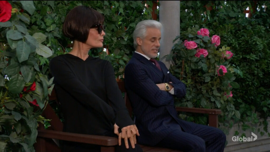 A disguised Phyllis sits beside Michael on a park bench.