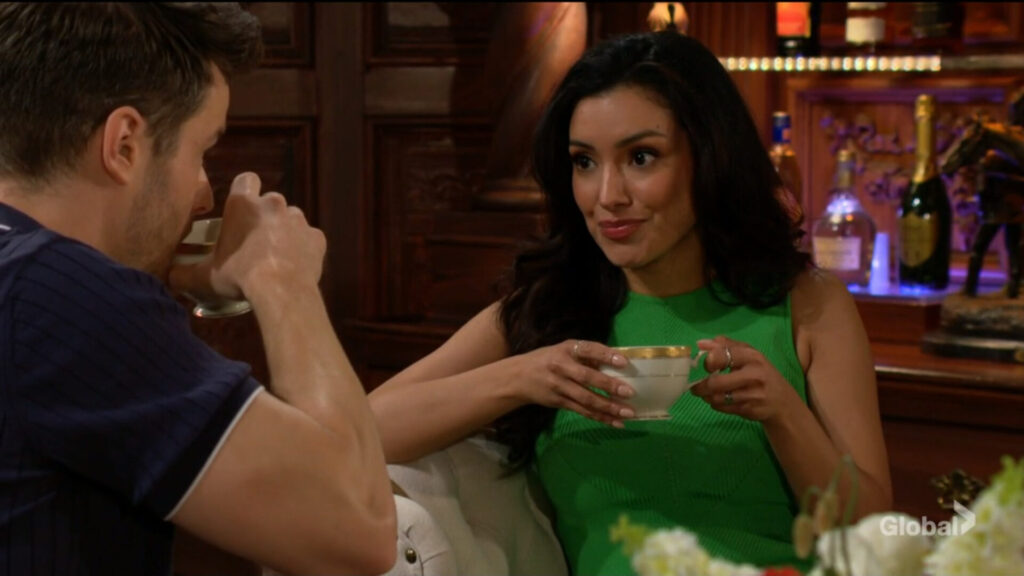 Audra holds a teacup as she talks with Kyle.