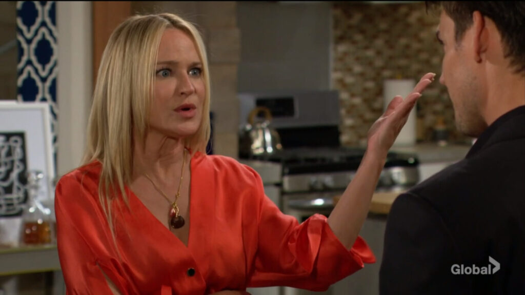 Sharon gestures as she talks with Adam.