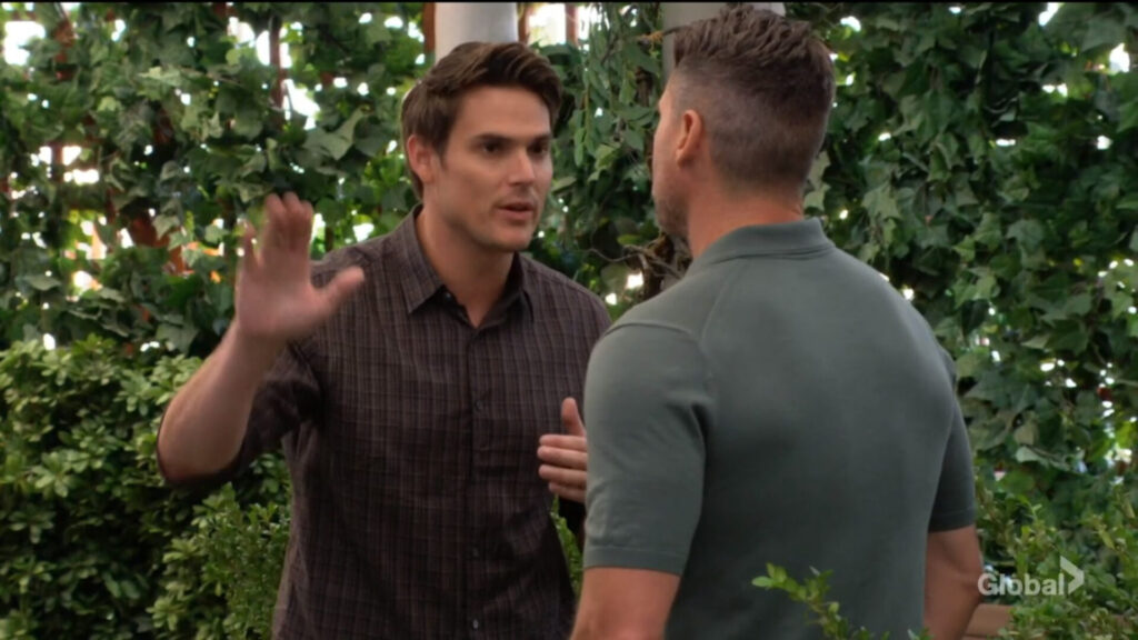 Adam holds up his hand as he talks to Nick.