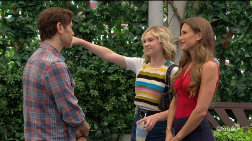 Lucy hugs Daniel as Heather watches.