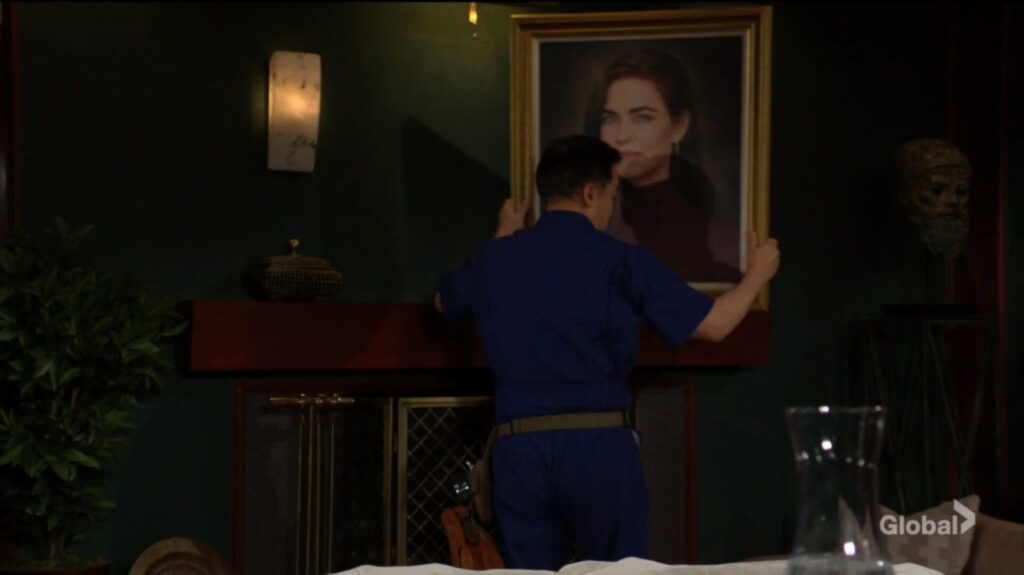 A worker removes Victoria's portrait.