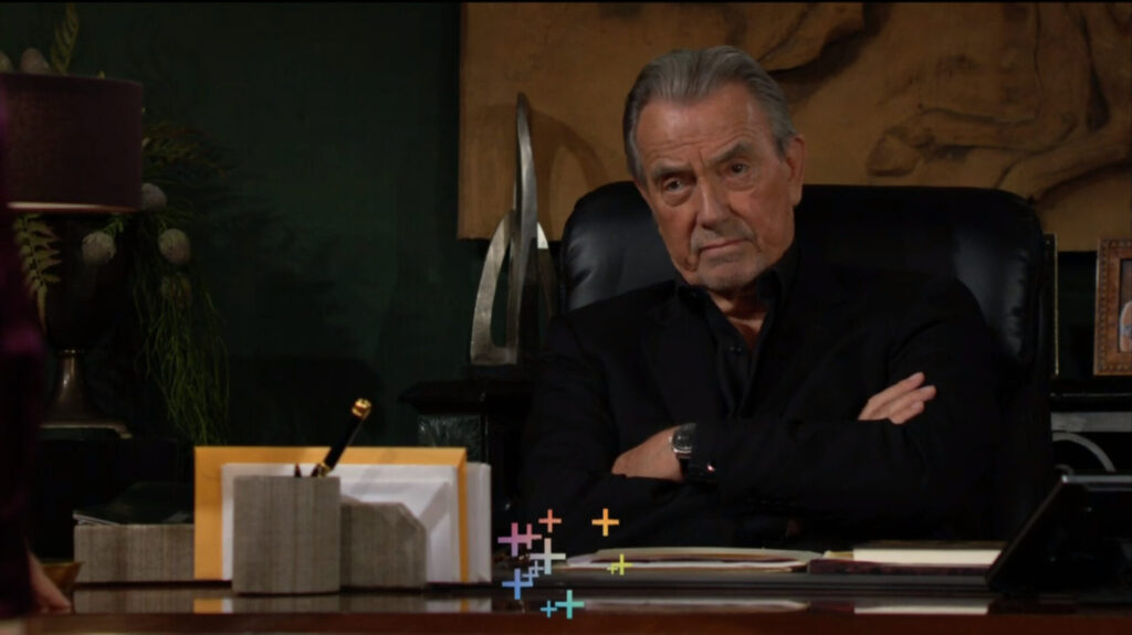 Victor folds his arms as he talks to Victoria.