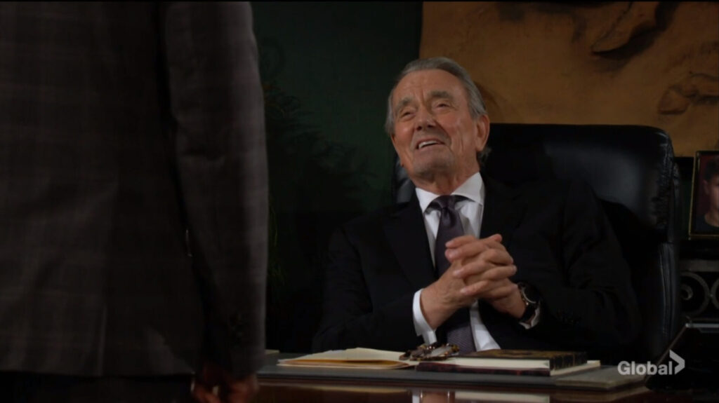 Victor Newman smiles and rubs his hands together.