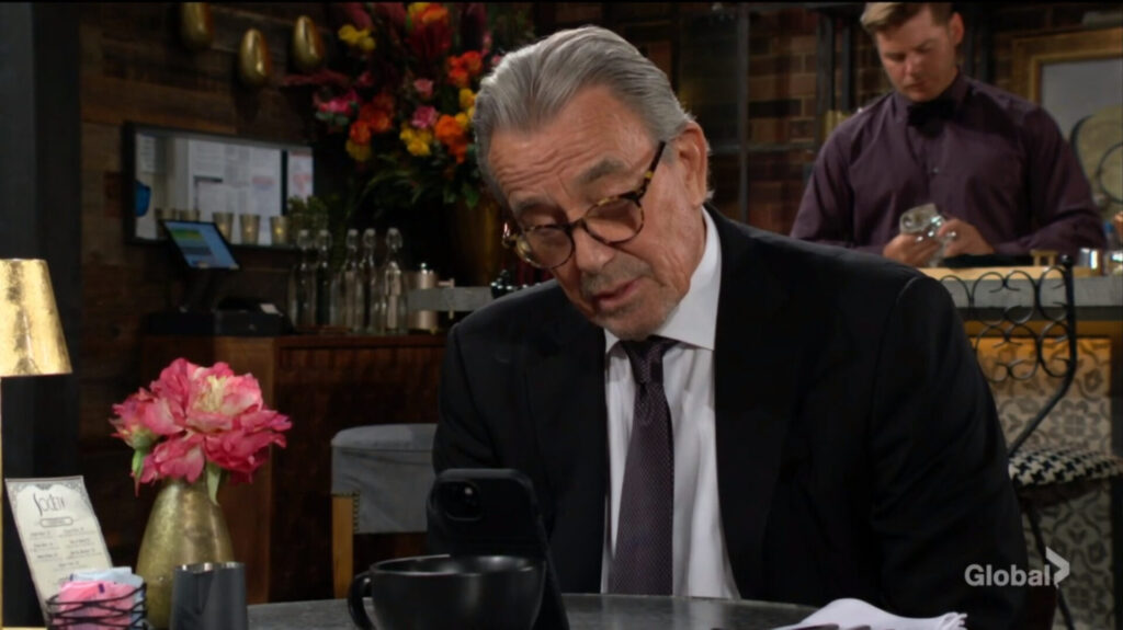 Victor looks at his phone as he talks to Jill.