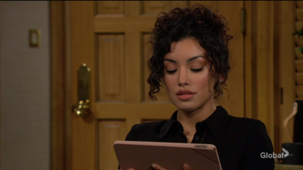 Audra looks at her tablet.
