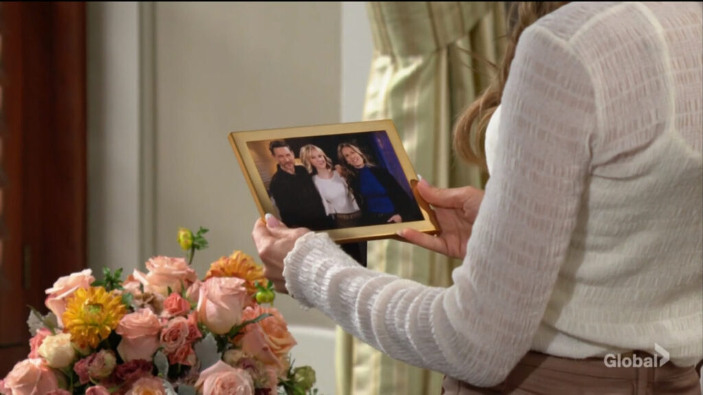 Heather holds a picture of herself, Daniel, and Lucy.