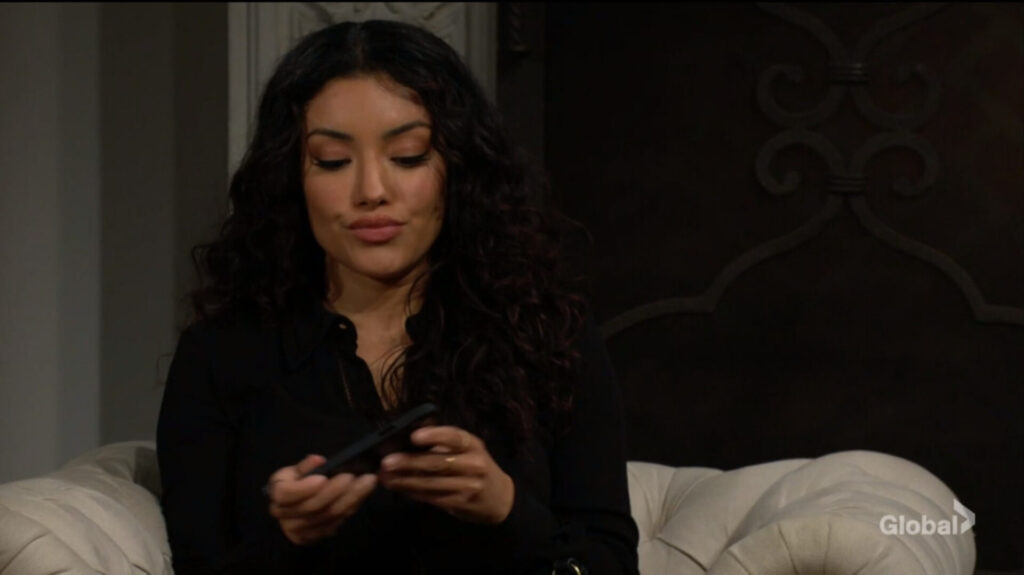 Audra Charles looks at her phone.