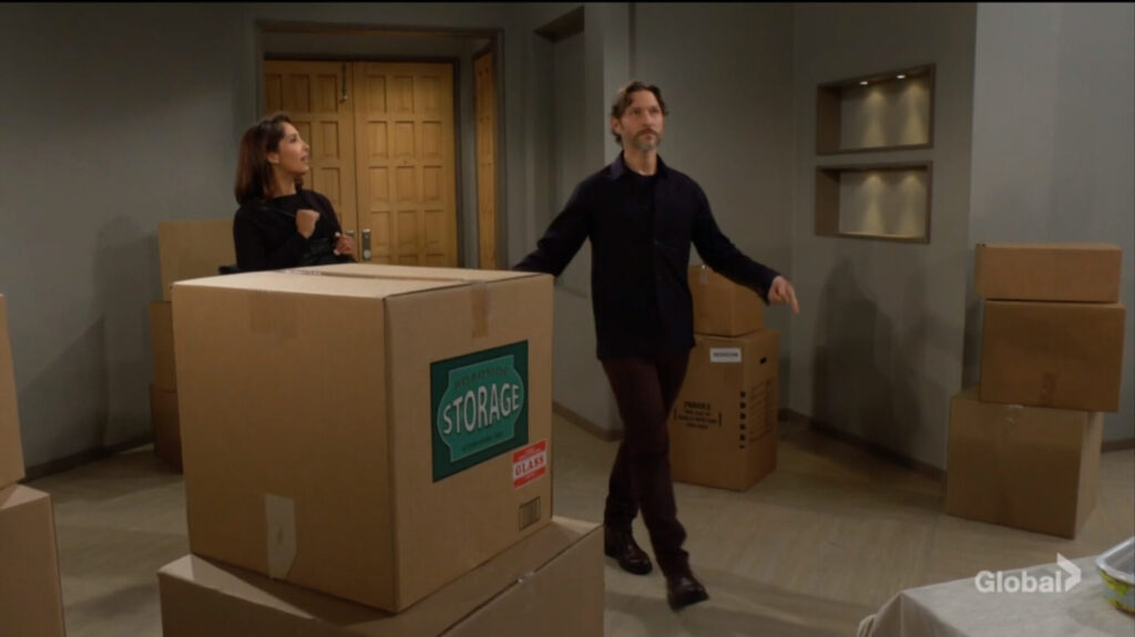 Daniel and Lily walk into a box-filled apartment.