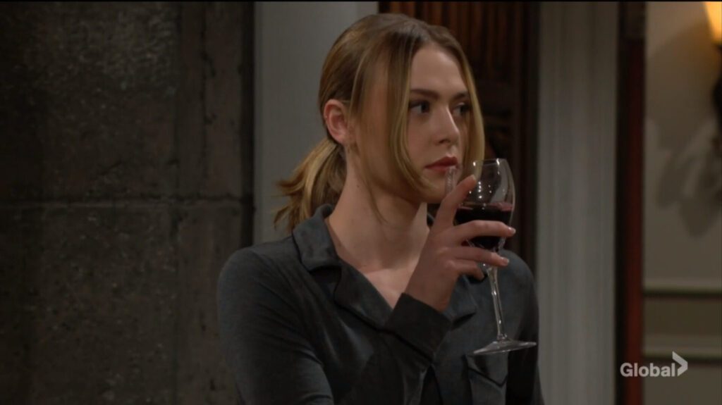 Claire takes a drink of wine.