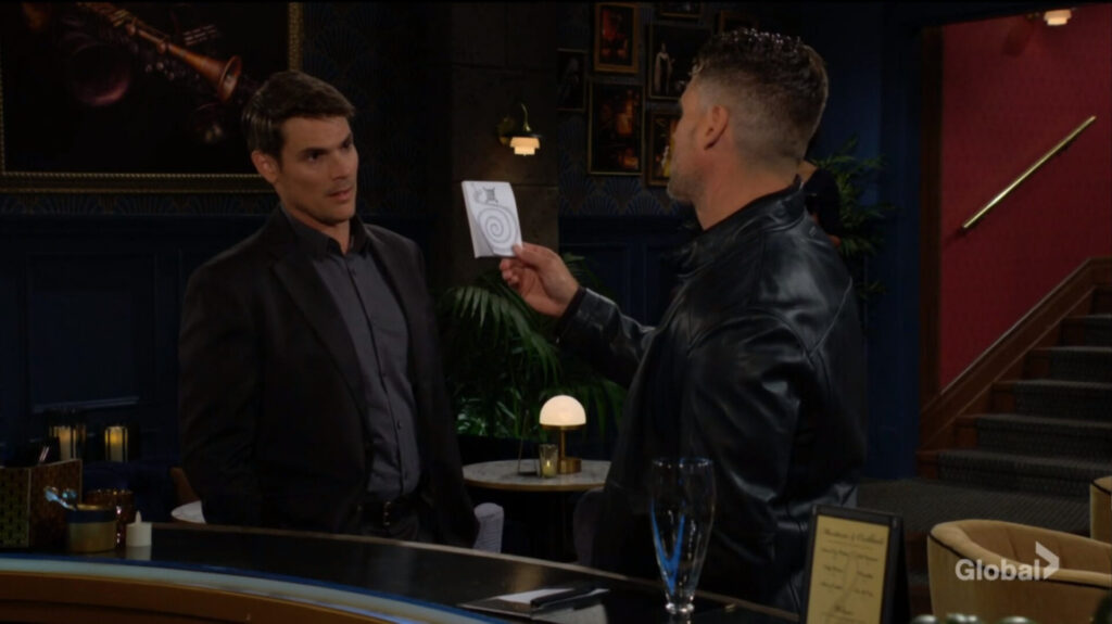 Adam shows Nick the notepad.