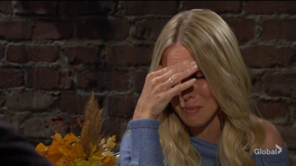 Christine wipes tears from her eyes.