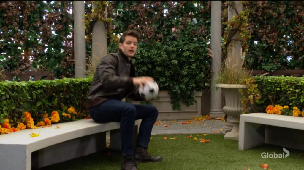 Kyle throws a soccer ball.