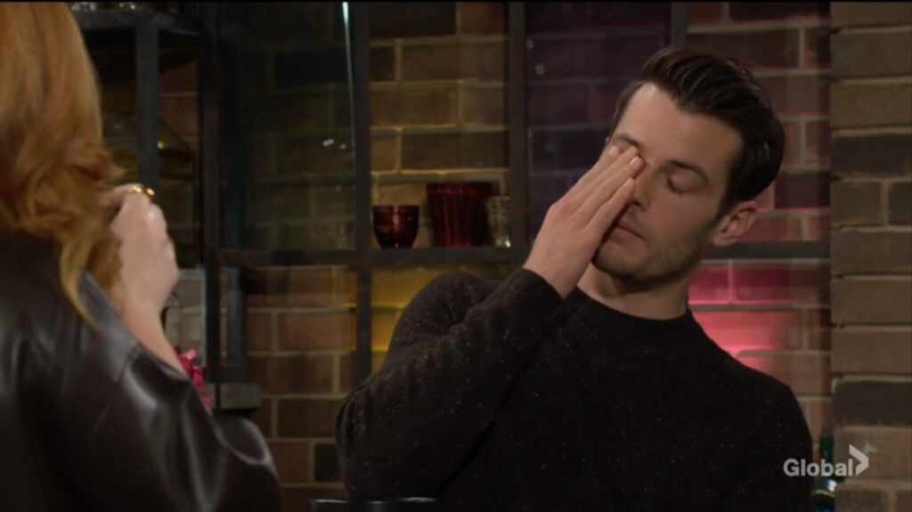 Kyle rubs his face.