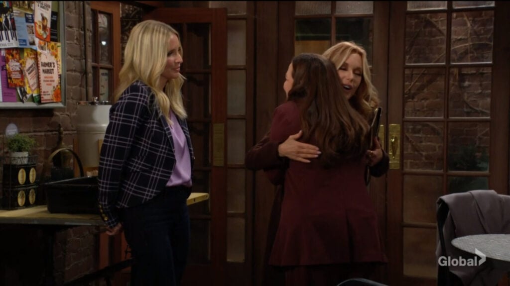 Lauren hugs Nina as Christine looks on.