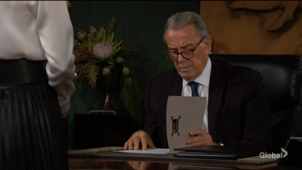 Victor Newman looks at a contract.