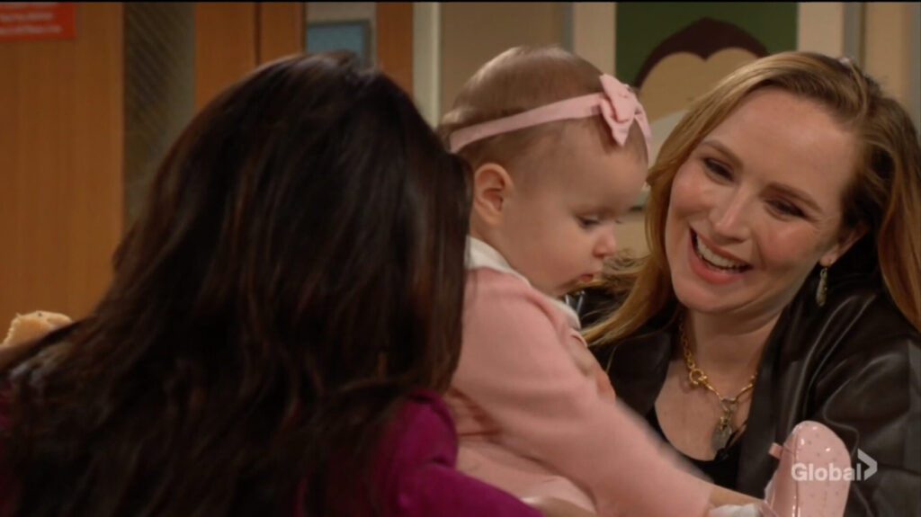 Mariah grins broadly as she holds Aria.