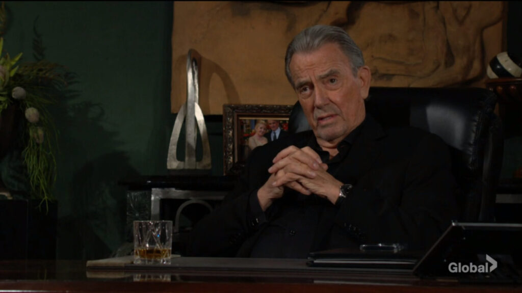 Victor Newman sits with hands folded.