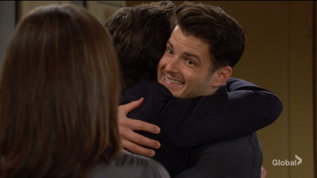 Kyle grins at his mom as he hugs Jack.