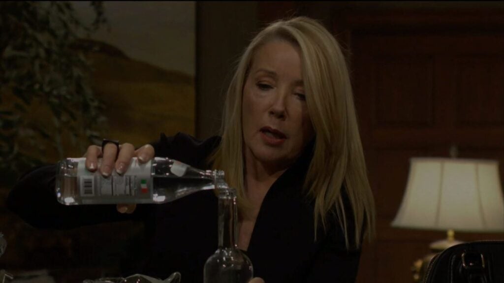 Nikki refills the vodka bottle with water.