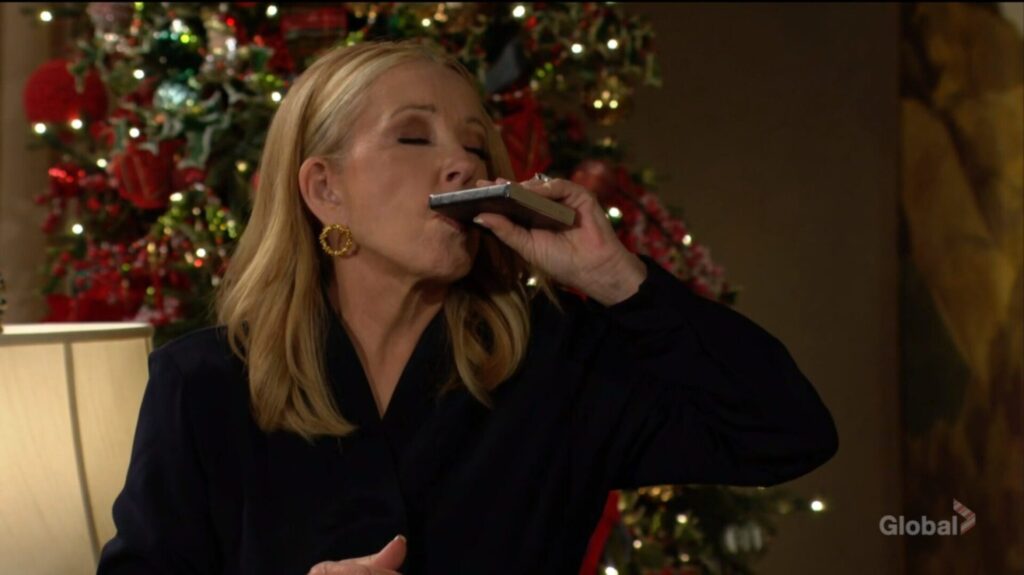 Nikki Newman takes a drink from her flask.