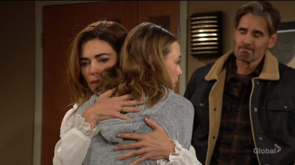 Victoria and Claire hug as Cole looks on.