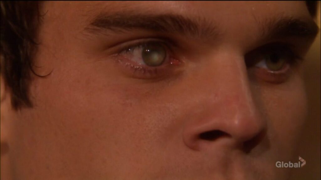 The fire is reflected in Kevin's eye.