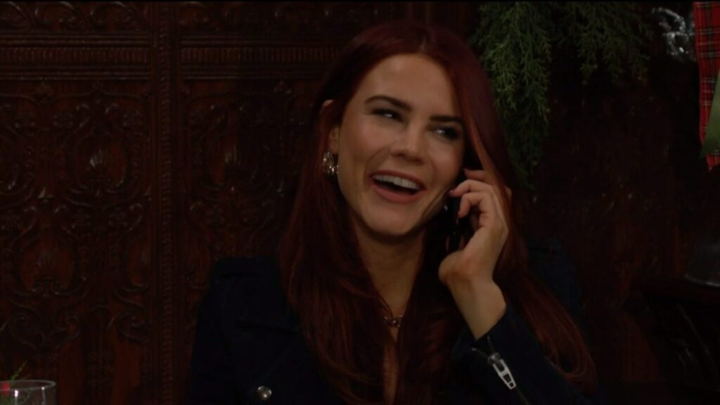 Sally laughs as she talks to Adam on the phone.