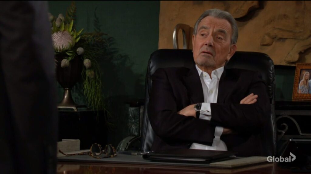 Victor Newman sits in his chair, arms crossed.